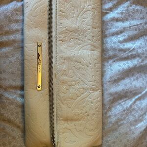 Elegant Cream Floral Embossed Clutch by [Brahmin]